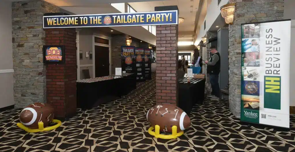Tailgate party event entrance with branded banner and inflatable football decor