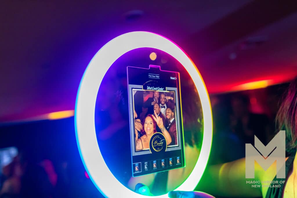 Guests interacting with Magic Mirror of New England's roaming photo booth experience at a corporate event in New England.